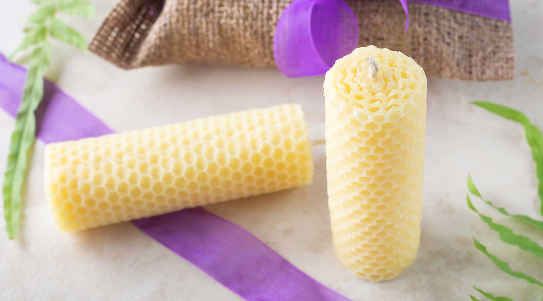 Handcrafted natural beeswax candles with a honeycomb texture
