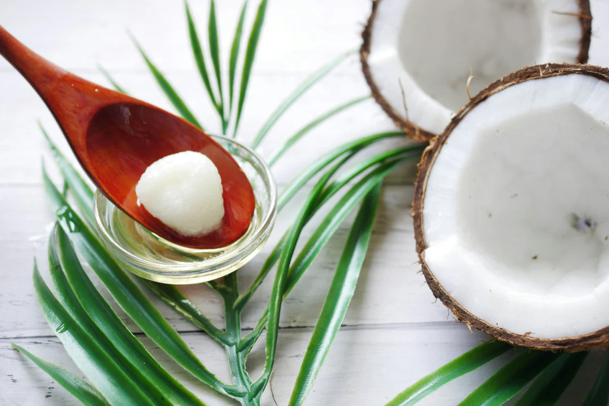 Virgin coconut oil beside fresh coconuts